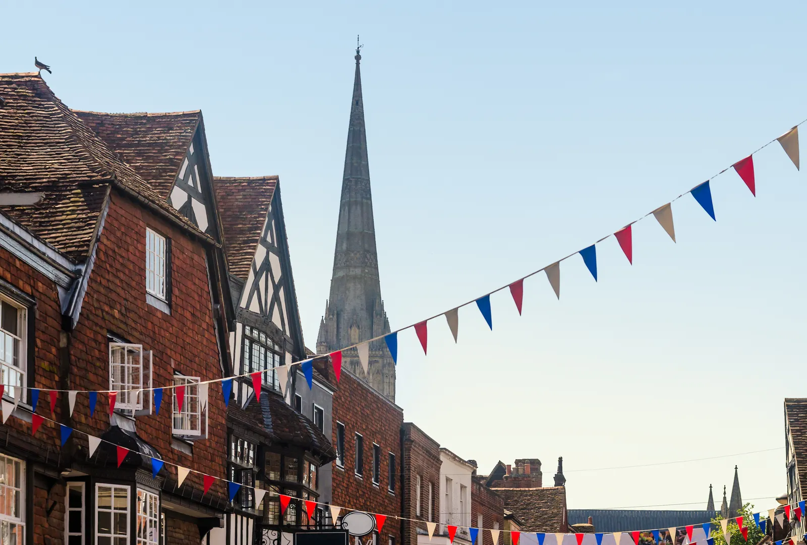 Bunting strung between old shopfronts on an English high street
